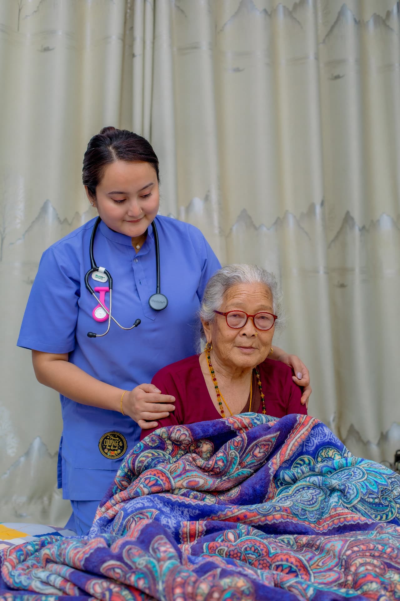 A Parivar nurse caring for an elderly patient at home
